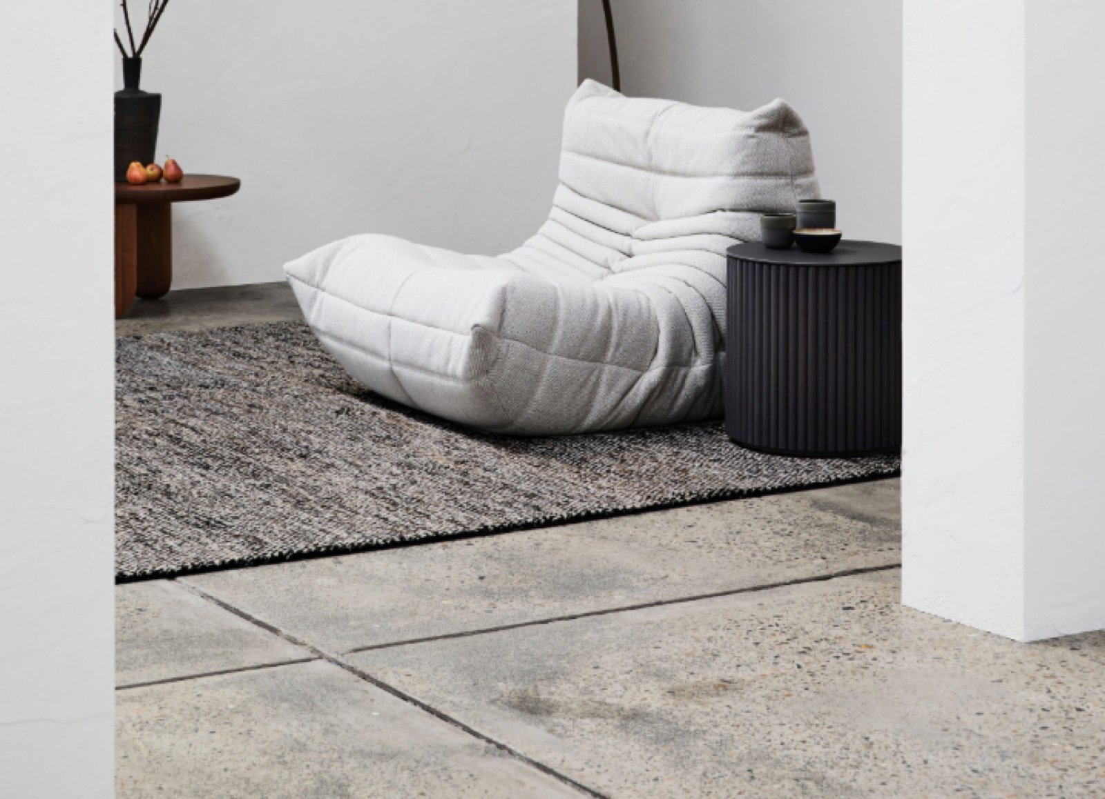 A handwoven rug in a minimalist, sunlit interior