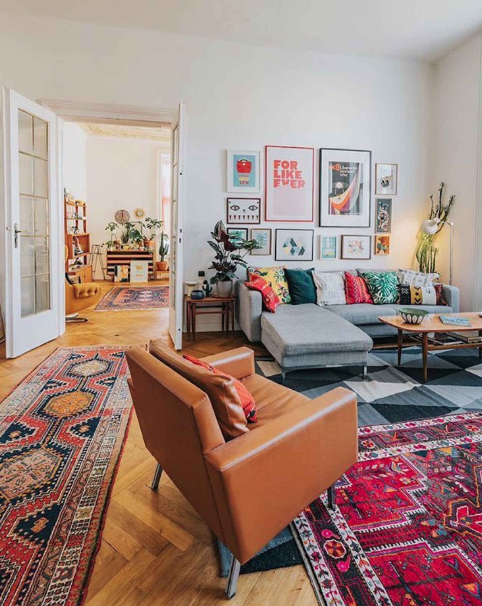 Handwoven rugs layered in a styled living room